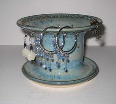 there is a blue bowl with earrings on it