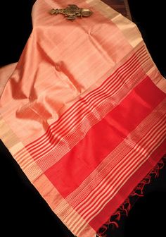 Embrace elegance with this Pure Raw Silk Saree in Coral, a timeless classic exuding sophistication. Crafted with finesse, the luxurious raw silk fabric drapes gracefully, offering both comfort and style. The serene coral hue adds a touch of warmth and vibrancy to your ensemble, perfect for any occasion. Adorning the saree is a Tissue Zari Red Border, delicately woven with metallic threads, adding a hint of opulence and grandeur. Whether for a formal event or a festive celebration, this saree pro Luxury Raw Silk Pre-draped Saree With Zari Weaving, Luxury Zari Weaving Raw Silk Churidar, Elegant Red Cotton Silk Dupatta, Fitted Red Tissue Silk Saree, Fitted Red Tussar Silk Saree, Fitted Red Tussar Silk Dupatta, Red Fitted Silk Saree, Fitted Red Silk Saree, Formal Red Art Silk Saree