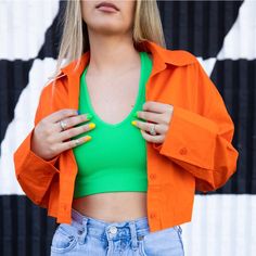 With A Juicy Color Like This, It's Hard To Say No! The Fresh Squeezed Buttondown Is A Vibrant Neon Orange Cropped Long Sleeve. Leave It Unbuttoned For An Effortless Cool Look! Seen Paired With The Vibrant Green Lounge Tank. True To Size. Model Is Wearing Size Small. 100% Cotton Spring Cropped Trendy Shirt, Trendy Collared Cropped Shirt For Spring, Trendy Collared Cropped Shirt With Buttons, Trendy Button-up Cropped Shirt For Day Out, Trendy Green Button-up Tops, Trendy Cropped Button-up Shirt, Spring Cropped Shirt With Button Closure, Spring Collared Cropped Shirt With Buttons, Spring Cropped Collared Shirt With Buttons