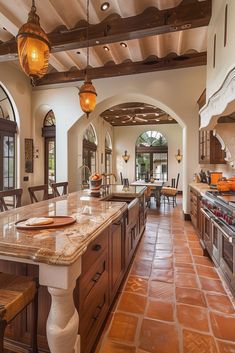 a large kitchen with an island in the middle and two ovens on each side