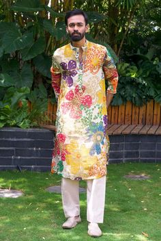 *PRODUCT DETAILS:- Offering a fresh and lively look, this off white kurta set features a vibrant orange rani purple blue and yellow floral print. The digital print all over floral design enhance its elegance. Ideal for daytime events ,sangeet or summer gatherings, style this kurta set with matching white jutis and a simple watch or bracelet to complete the ensemble. *FEATURES:- Color: Off-white digital print Fabric: 100% Polyester French Crape Design Type: Digital Print kurta floral design all over Items Included:  (i)  Kurta ,  (100% polyester) (inner layer of 100% cotton)                               (ii) Pant Elastic (100% heavy tensile dyed) Neckline: Stand Collar Sleeve Type: Full Sleeves Wash Care: Dry Clean Only Disclaimer Text: Product color may slightly vary due to photographic l White Kurta Set, Latest Kurta Designs, Sage Green Floral, Mens Kurta Designs, White Kurta, Straight Kurta, White French, Floral Outfit, Digital Print Fabric