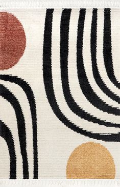 an area rug with black, orange and white circles on it's side in front of a white background