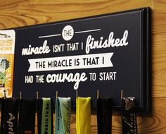 there is a sign on the wall that says, i can't finish finished the miracle is that i had the courage to start