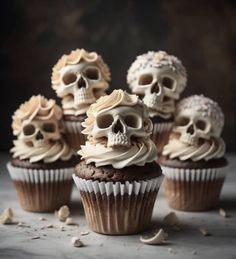 several cupcakes with frosting and skulls on them