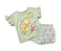 Warm-weather days call for charming outfits, and this casual tee and shorts set is sure to delight the Disney fan in your life. Little ruffles trim the sleeves of the tee and the hem of the shorts for playful panache, and the tee features a lovely graphic of Winnie-the-Pooh with Piglet. The shorts complete the look with a gingham pattern and daisies. Spring Short Sleeve Sets With Character Print, Spring Character Print Short Sleeve Sets, Playful Cartoon Print Sleepwear For Spring, Playful Short Cotton Tops, Playful Short Tops For Spring, Cotton Cartoon Print Short Top, Cute Short Cotton Tops, Playful Character Print Sets For Spring, Short Cotton Top With Cartoon Print