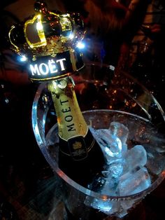 a bottle of champagne sitting on top of an ice bucket