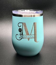 the monogrammed stemless wine tumbler is made from stainless steel and has a light blue color