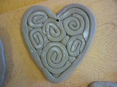 a heart shaped cookie sitting on top of a wooden table