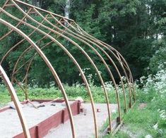 a metal structure sitting in the middle of a field