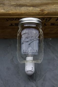 a mason jar is mounted on the wall