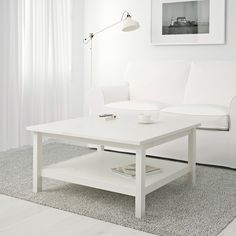 a white coffee table sitting on top of a hard wood floor