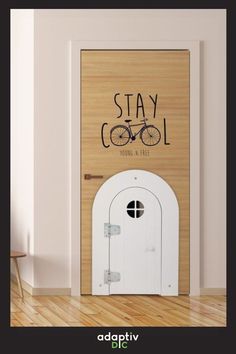 an open door with the words stay cool written on it in front of a wooden wall