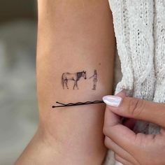 a woman with a horse tattoo on her arm