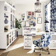 an office with blue and white decor on the walls