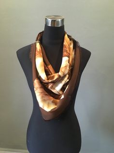 "Vintage wool feel challis with fringe. This large scarf features a maple lef pattern in cream and brown colorways. Tags are missing. The scarf measures 33\" x 34\". In very good condition. FREE SHIPPING EVERYWHERE Prices are listed for Canada and USA only but if you wish to have them shipped elsewhere, please message me the shipping address and I will gladly send you a quote. We proudly reuse shipping material when we can to cut down waste to prevent our beloved planet from drowning in a sea of Brown Bohemian Silk Shawl Scarf, Bohemian Brown Silk Shawl Scarf, Brown Bohemian Silk Scarves, Bohemian Brown Silk Scarves, Bohemian Brown Silk Scarf, Bohemian Brown Silk Scarf For Fall, Brown Silk Scarves For Fall, Brown Shawl Scarf One Size, Brown Shawl Scarf