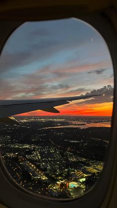 the view from an airplane window at sunset