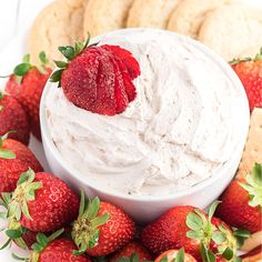 a white plate topped with strawberries and crackers