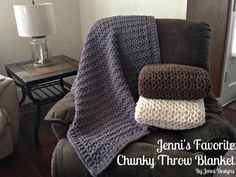 three crocheted blankets stacked on top of each other in front of a couch