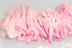 a pile of pink tissue sitting on top of a white table