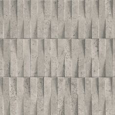 a gray brick wall textured with small squares and lines in varying sizes, from diagonal to horizontal