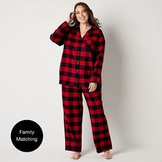 Perfect for lounging at home or a matching family photo moment during the holidays, this North Pole Trading Co. women's plus 2-piece pajama set features a classic red and black buffalo plaid pattern. Made from cotton-flannel, it includes a long-sleeve button-down top with a notch collar and a chest slip pocket paired with matching drawstring pants with side slip pockets.# Pieces In Set: 21st Piece Description: Top1st Piece Collar: Notch Collar1st Piece Pockets: 1 Chest Slip Pocket(s)1st Piece Ap Photo Moment, Buffalo Plaid Pattern, Christmas Pjs, Matching Family Pajamas, Family Pajamas, Notch Collar, North Pole, Drawstring Pants, Cotton Flannel