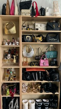 a closet filled with lots of purses and handbags next to a wall mounted shelf