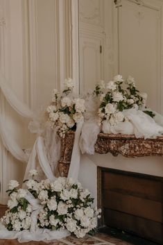 flowers are sitting on the floor in front of a mirror and some kind of decoration