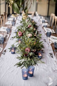 a long table with candles and flowers on it