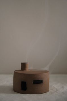 This incense holder is the perfect replica of an adobe-style house. The flame-resistant base plate is designed to hold the incense, while a glazed surface shields the stoneware from heat. Witness the aromatic smoke curling out of the tiny earthenware dwelling's chimney. Diy Incense Holder, Whittling Projects, Ceramic Vessels, Ceramic Incense Holder, Ceramic Boxes, Sea Pottery, Diy Holder, Ceramic Gifts, Ceramics Projects