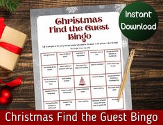 christmas find the guest bingo game on a wooden table with presents and red ribbon