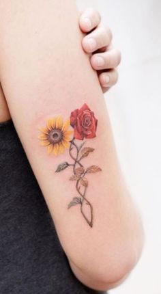 a woman's arm with two roses and a sunflower tattoo on the side