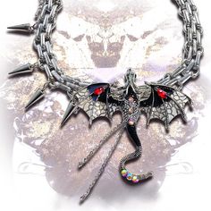 This choker is made of alloy and is decorated with a black and red dragon or a purple dragon, along with tassels. It features a unique and eye-catching design that adds a touch of edgy style to any outfit. Perfect for those who love to make a bold fashion statement, this choker is a must-have accessory for any kawaii or lolita look. The dragon motif adds a mystical and whimsical touch, making it a standout piece for any occasion.  The price is for a choker only, others are not included. Black Fantasy Necklaces For Parties, Unique Black Jewelry For Alternative Fashion, Punk Metal Jewelry For Fantasy Events, Black Metal Jewelry For Fantasy Events, Adjustable Black Jewelry For Fantasy Events, Fantasy Metal Jewelry For Alternative Fashion, Black Fantasy Choker As A Gift, Black Fantasy Style Choker As Gift, Fantasy Style Adjustable Black Necklace