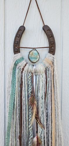 a dream catcher hanging on the side of a door