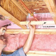 a man is working on the ceiling in his house with tools and insulation tape around him