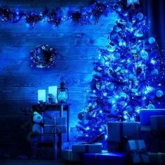 a blue christmas tree with presents under it