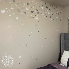 a bedroom with hearts painted on the wall