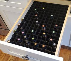 an open drawer with many bottles in it