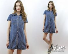 Vintage nineties DENIM MINI DRESS. Snap buttons up front. Chest pockets. 100% cotton. Classic wardrobe staple. Model is 5'9. Her measurements are: bust=34 inches, waist=26 inches, & hips=34 inches. The dress fits as shown on her. We measure on a flat surface from seam to seam. Bust, waist, & hip measurements have already been doubled. We suggest you compare our measurements to a garment you already own and know fits you well to ensure a proper fit. label: gap approximate size: S vintage size on tag: 8 material: 100% cotton across shoulders: 14.75 inches arm length: 6.25 inches bust: 34 inches waist: 31 inches hips: 34 inches length: 32.5 inches VERY IMPORTANT WE DO NOT TAKE RETURNS FOR ITEMS THAT DO NOT FIT. We take extreme care to measure each item accurately, so please take note of the m Retro Cotton Denim Dress With Pockets, Vintage Medium Wash Denim Dress With Pockets, Vintage Denim Blue Denim Dress With Pockets, Vintage Denim Button-up Dress, Vintage Button-up Denim Dress For Spring, Vintage Washed Denim Dress For Spring, Vintage Blue Denim Dress With Pockets, Retro Blue Denim Dress With Pockets, Fitted Vintage Button-up Denim Dress