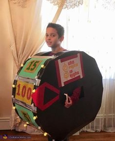 a man in a costume made to look like a wheel of fortune with lights on