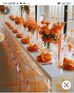 an image of a table setting with orange flowers on the tables and place settings for guests to eat