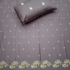 a bed with two pillows on top of it and a pillow case in the middle