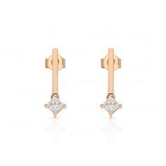 These sleek, modern bar earrings feature two princess-cut diamonds set in lustrous 10k gold. Perfect for the fashion-conscious, contemporary woman, they will be an eye-catching addition to any outfit. Modern Rose Gold Earrings With Single Diamond, Modern Linear Earrings With Diamond Accents, Modern Diamond Linear Earrings, Two Princess, Diamond Bar, Modern Bar, Bar Earrings, Princess Cut Diamonds, 10k Gold