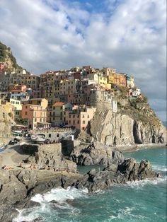 the town is on top of a cliff by the ocean