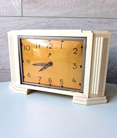 a small clock sitting on top of a table