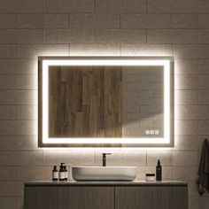 a bathroom with a sink, mirror and lights on the wall above it's counter