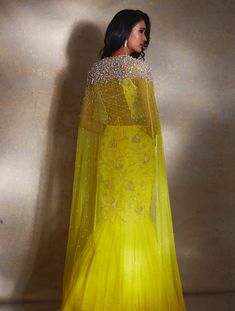 Yellow power shoulder crop featuring hand-embellished ivory camellia flowers paired with a tiered georgette lehenga and embellished waistband with ivory drops & a ruffled dupatta.From Shloka Khialani's Winter Sun collection.DELIVERY TIMEPlease allow 6-8 weeks for your outfit to arrive.FABRIC DETAILSGeorgette, NetProfessional cleaning only. Reception Gown With Ruffles In Georgette, Festive Organza Dress With Cape Sleeves, Floor-length Ruffled Anarkali Set For Wedding, Traditional Drape Wedding Gown With Ruffles, Designer Gown With Ruffles, Anarkali Organza Dress With Cape Sleeves, Festive Floral Organza Gown, Organza Choli With Cape Sleeves For Reception, Floor-length Ruffled Dupatta For Weddings