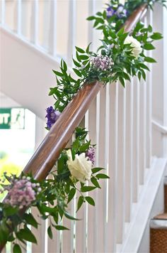 flowers and greenery are on the banister