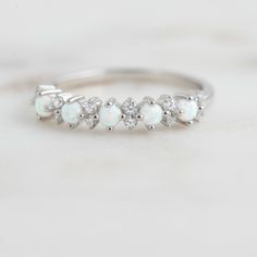 Delicate opal ring, that is perfect for stacking or wearing alone. A true beauty and must have! Sweet, simple, and dainty ring. Perfect for a minimalist look. ☆ Details ☆ * Made of 925 Sterling Silver * Available in 14k Gold Plating, Rose Gold Plating or Rhodium Plated * We use a THICK, DURABLE 14k GOLD plating - for a piece that will last you years to come! * VERY HIGH QUALITY * Available in sizes 4, 5, 6, 7, 8, 9, or 10 ✈️READY TO SHIP! Ships out same day, for quick delivery. Domestic Orders a Elegant White Opal Crystal Ring, Delicate White Opal Ring, White Dainty Opal Ring, White Dainty Opal Gemstone Ring, Delicate White Opal Round Ring, White Cubic Zirconia Stackable Crystal Ring, Elegant Silver Opal Stackable Rings, Delicate White Cubic Zirconia Rings, White Dainty Opal Birthstone Ring