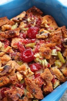 a blue casserole dish filled with cranberry and walnuts, nuts, and dried cherries