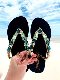 Description The beautiful rhinestone and customizable Flip Flops for the beach brides, bridesmaids, vacation, honeymoon or any occasion you desire to look gorgeous. Perfect in any outfit! Being unique and stunning on design, these flip flops must be your must-have item! The sandal is anti-slip, comfortable and durable as it is made from high quality rubber from the South of Thailand, where is famous for the best rubber tree. Moreover, the crystals are decorated on the sandal with effective adhes Embellished Sandals For Beach Party, Embellished Sandals For Beach Season Parties, Elegant Open Toe Beach Flip Flops, Elegant Open Toe Flip Flops For The Beach, Adjustable Embellished Sandals For Beach Season, Adjustable Sandals With Rhinestones For Beach Season, Adjustable Rhinestone Sandals For Beach Season, Adjustable Open Toe Flip Flops For Party, Gold Rhinestone Flip Flops For Vacation